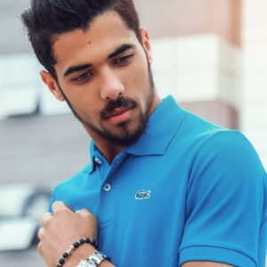 Man Wearing Blue Lacoste Polo Shirt and Silver-colored Analog Watch